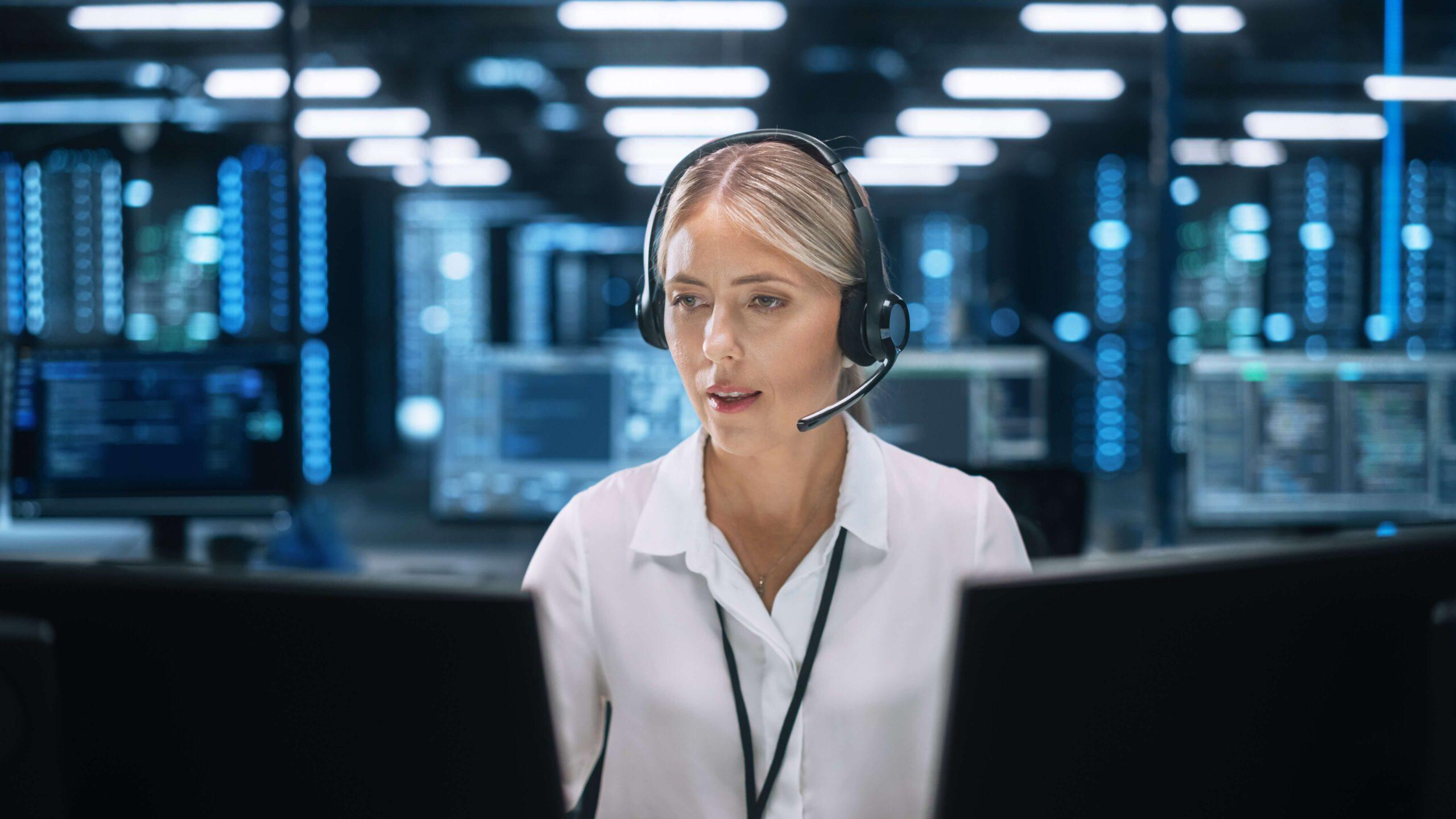 Woman customer representative looking at computer screens