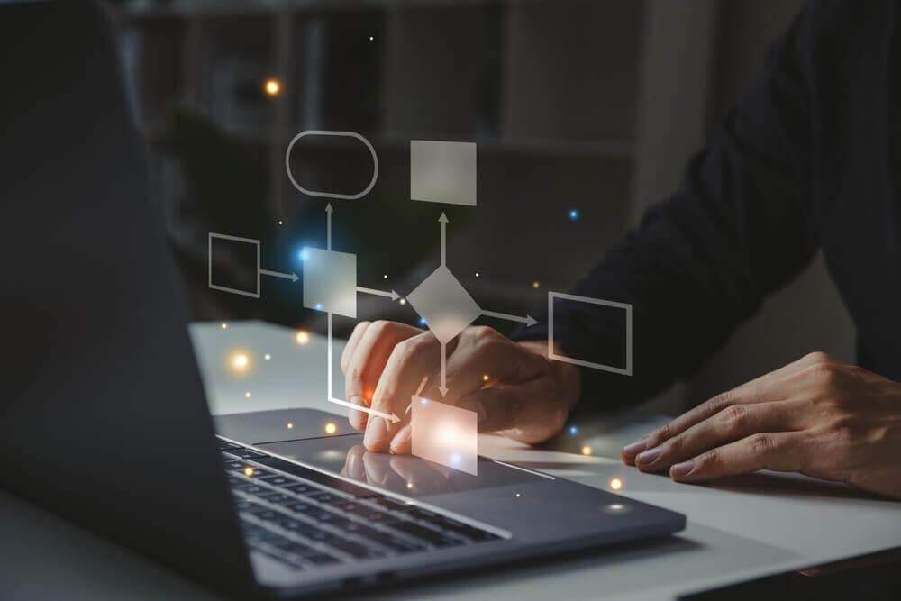 Person creating digital flowchart and diagrams