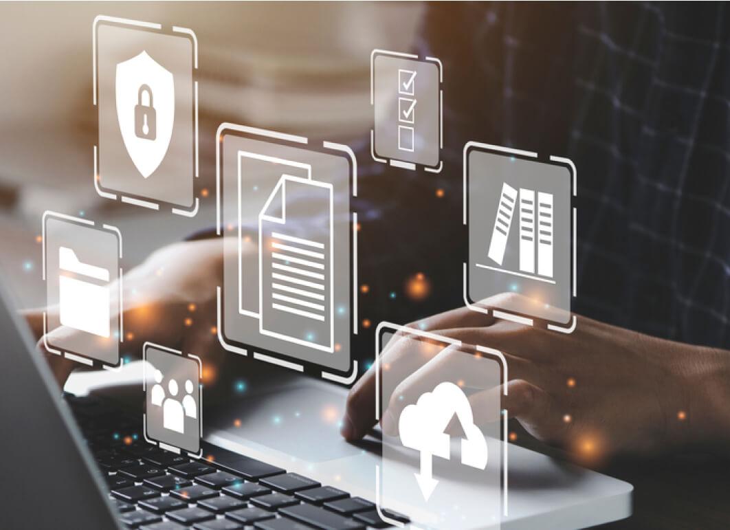 Man using laptop behind data related iconography